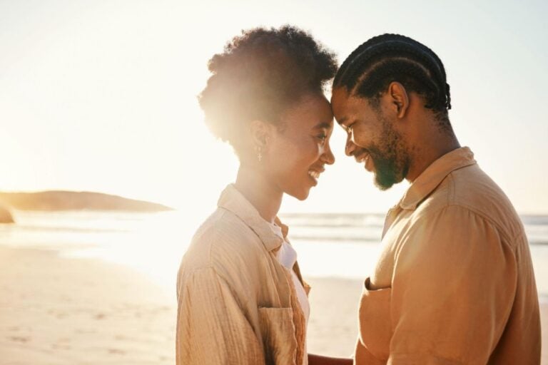 African couple reflecting on their relationship at sunset