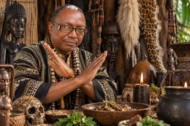 Carlos Mukuru making a clear no gesture during a traditional spiritual consultation